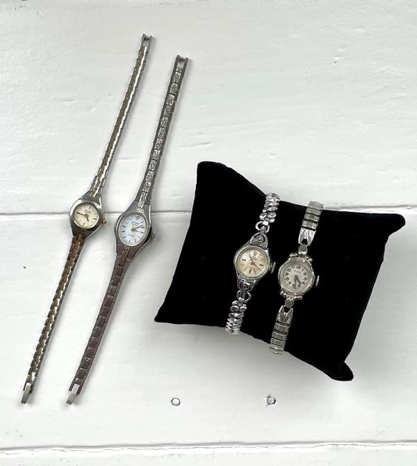 Silver vintage watches on velvet pillow